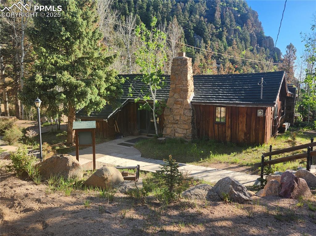 292 Sugar Loaf Road Manitou Springs, CO 80829 - Photo 10 of 12 a backyard of a house with yard and tree