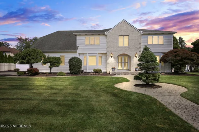 a front view of a house with a garden