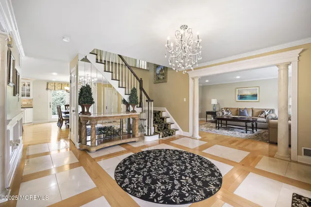 a kitchen with stainless steel appliances granite countertop a table chairs sink refrigerator and cabinets