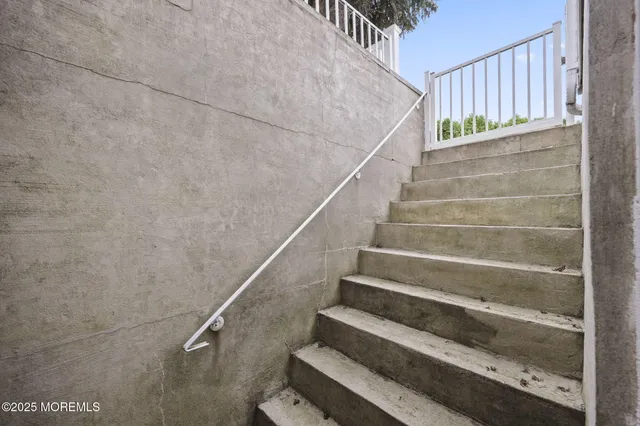 a view of staircase with wooden floor and stairs