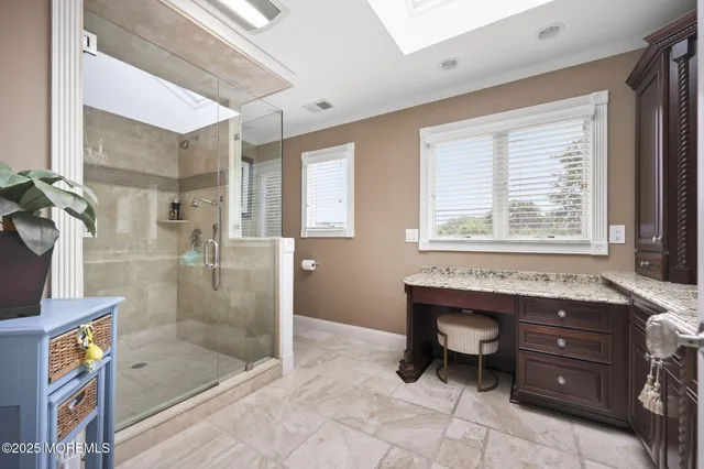 a bathroom with a granite countertop sink a toilet and shower