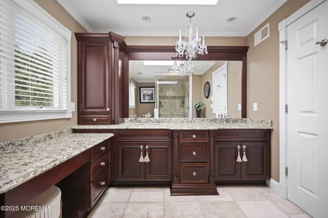 a room with a bed and a chandelier