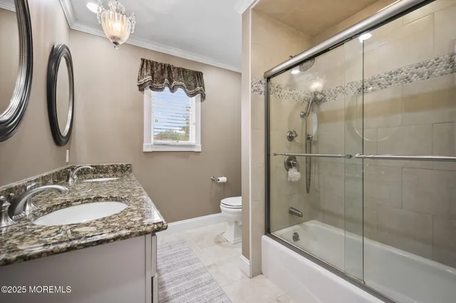 a bedroom with a large bed and ceiling fan