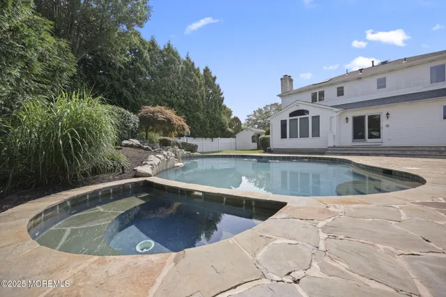 a view of a house with swimming pool and sitting area