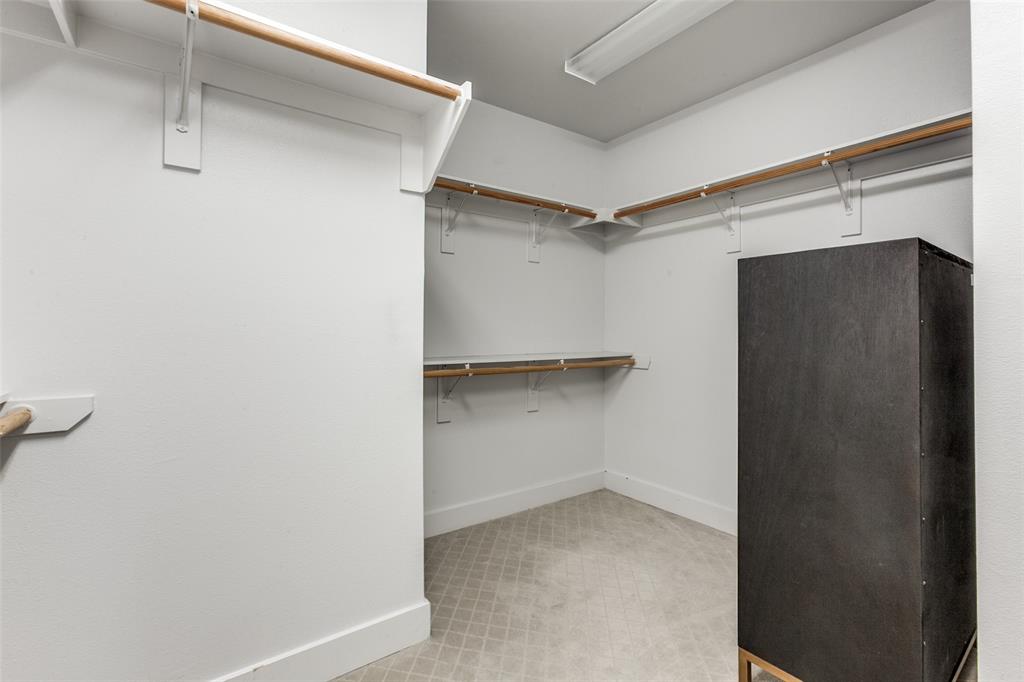 5055 Addison Circle, Unit 205 Addison, TX 75001 - Photo 17 of 24 Large walk in closet in primary bedroom/bath