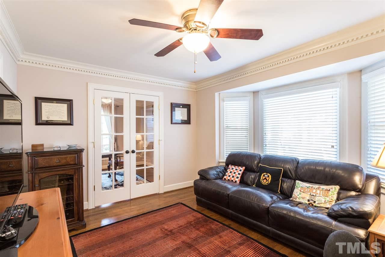 7728 Rainwater Road Raleigh, NC 27615 - Photo 12 of 30 Beautiful hardwood floors, crown molding, ceiling fan, smooth ceilings, and glass French doors.