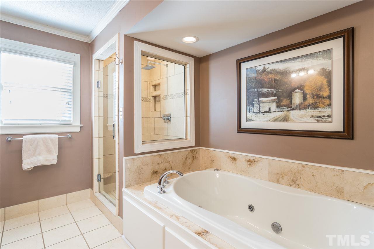 7728 Rainwater Road Raleigh, NC 27615 - Photo 19 of 30 Master bath provides a jetted tub with tile surround and ceramic tile flooring.