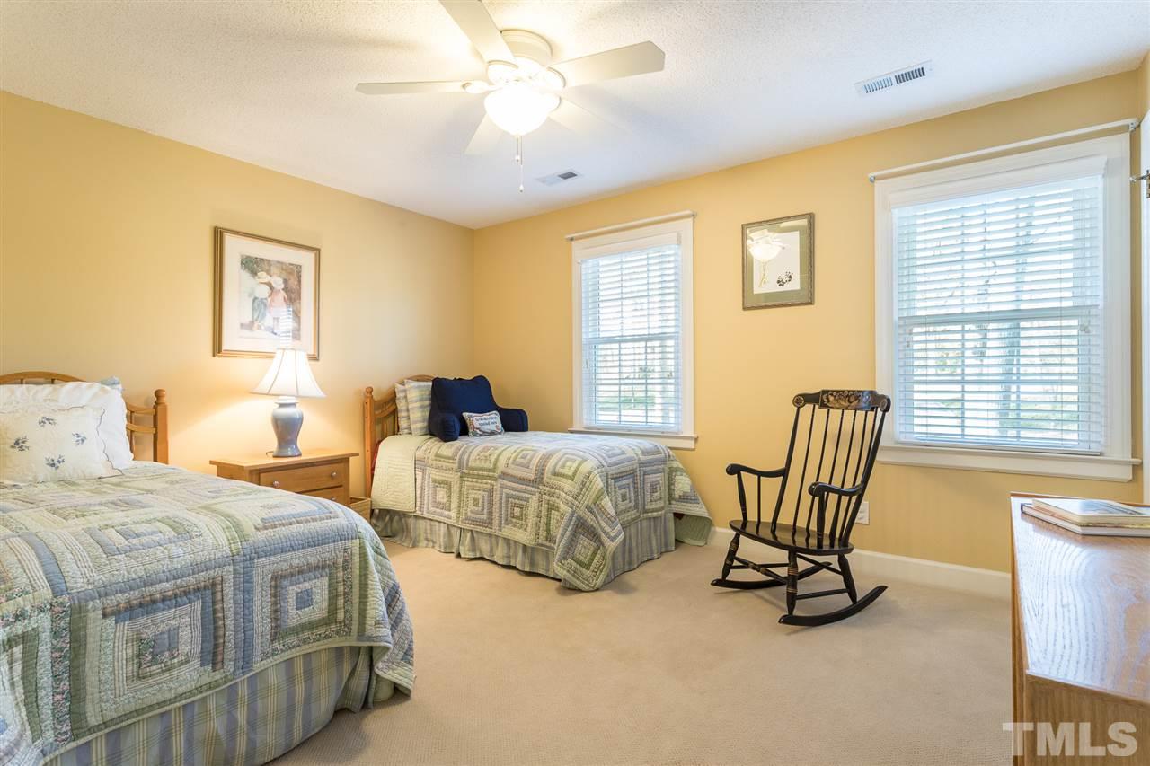 7728 Rainwater Road Raleigh, NC 27615 - Photo 20 of 30 Features include a ceiling fan, two large windows with plantation blinds and a double door closet.