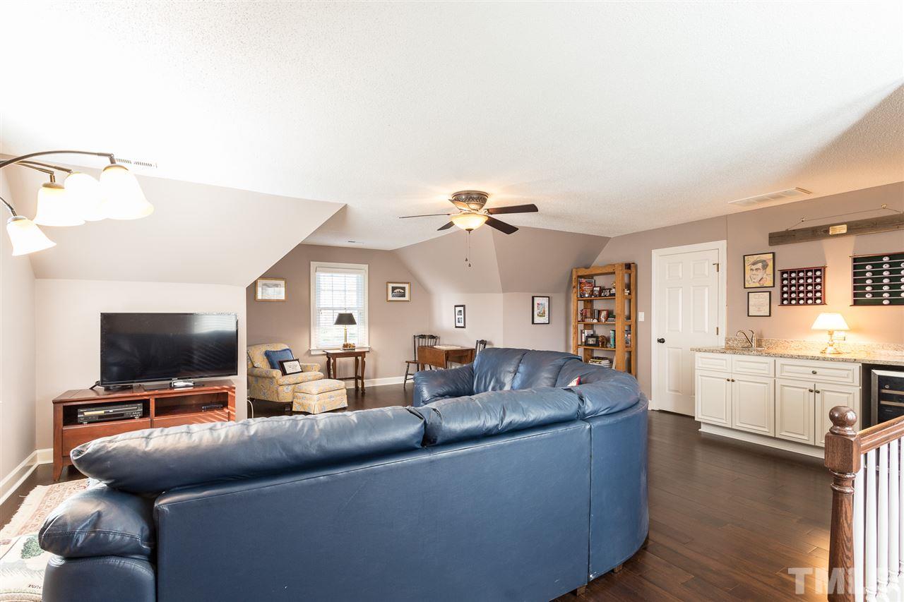 7728 Rainwater Road Raleigh, NC 27615 - Photo 26 of 30 A reading or play nook is located in the front of the bonus room. The remainder of the room easily accommodates a large sectional sofa (available for sale). A back staircase leads down to the family room.