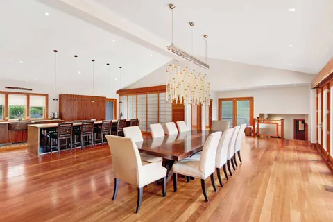 a dining room with furniture window and wooden floor