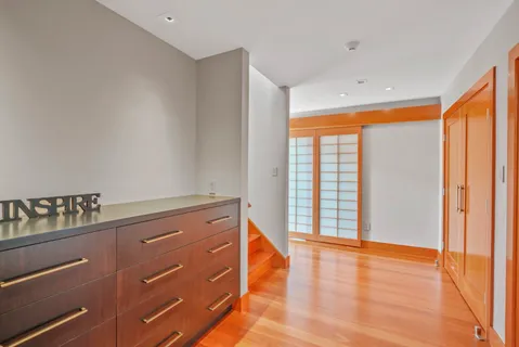 a view of room with window and wooden floor