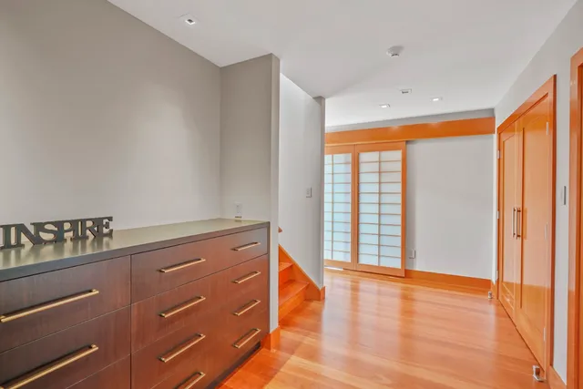a view of room with window and wooden floor