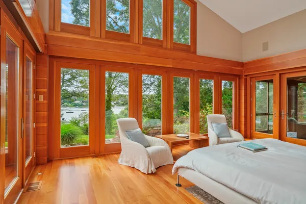 a bedroom with furniture and large windows