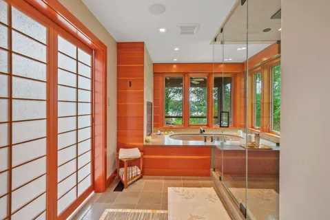 a bathroom with a large tub and shower