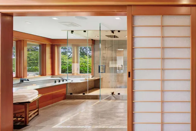 a large white kitchen with a large window