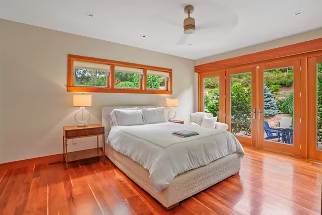 a bedroom with a bed and a large window