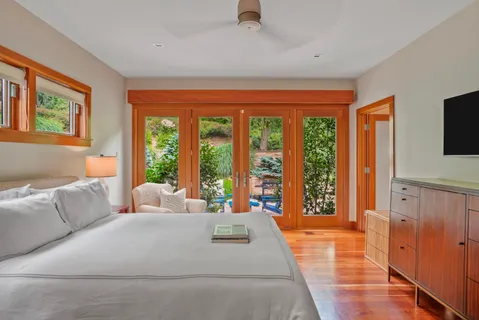 a living room with furniture and large windows