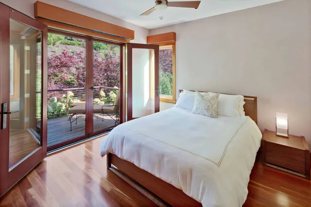 a bedroom with a large bed and a large window