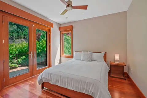 a bed sitting in a bedroom next to a window