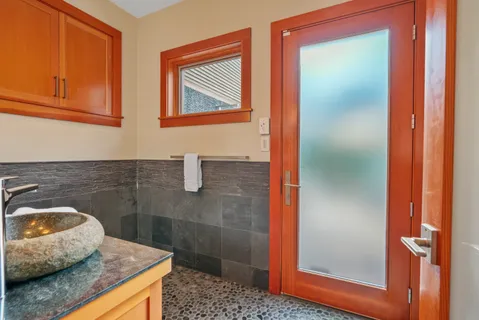 a bathroom with a granite countertop sink and a mirror