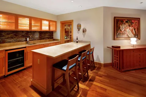 a kitchen with stainless steel appliances granite countertop a stove a sink dishwasher and a stove with wooden floor