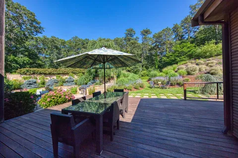 a view of a chairs and table under an umbrella in the patio