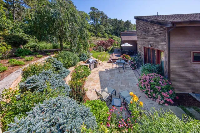 a view of a chair and tables in the patio in front of a house
