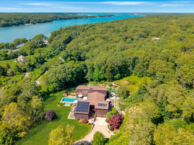 an aerial view of a house with a lake view