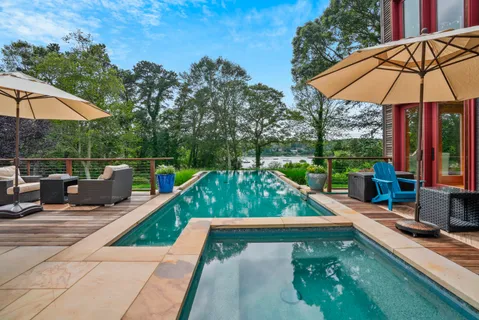 swimming pool view with a seating space