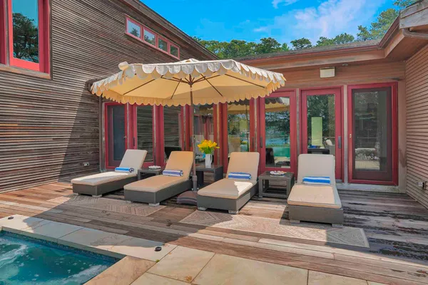 a view of a patio with a table and chairs under an umbrella