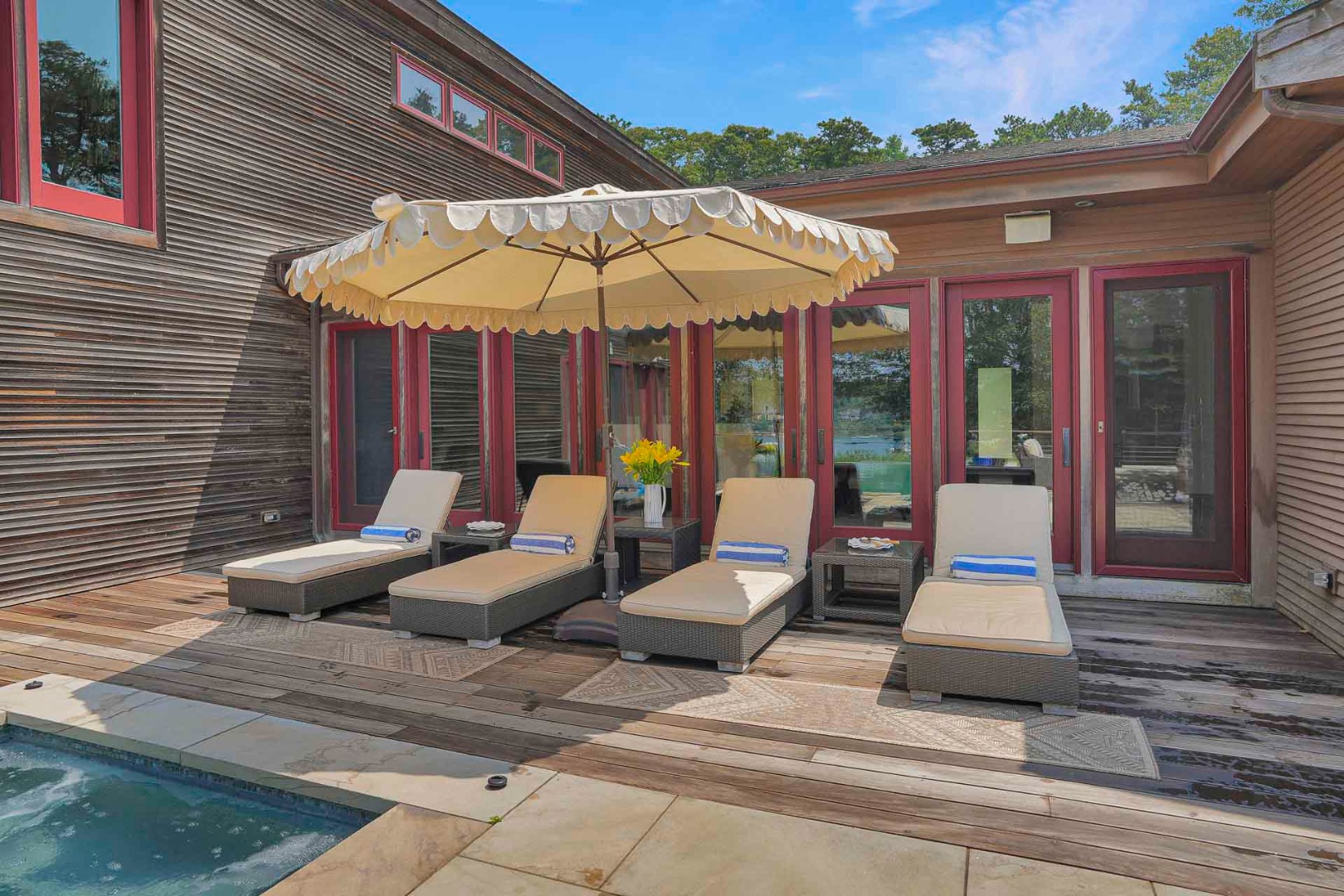 400 Barnes Road Oak Bluffs, MA 02568 - Photo 7 of 45 a view of a patio with a table and chairs under an umbrella