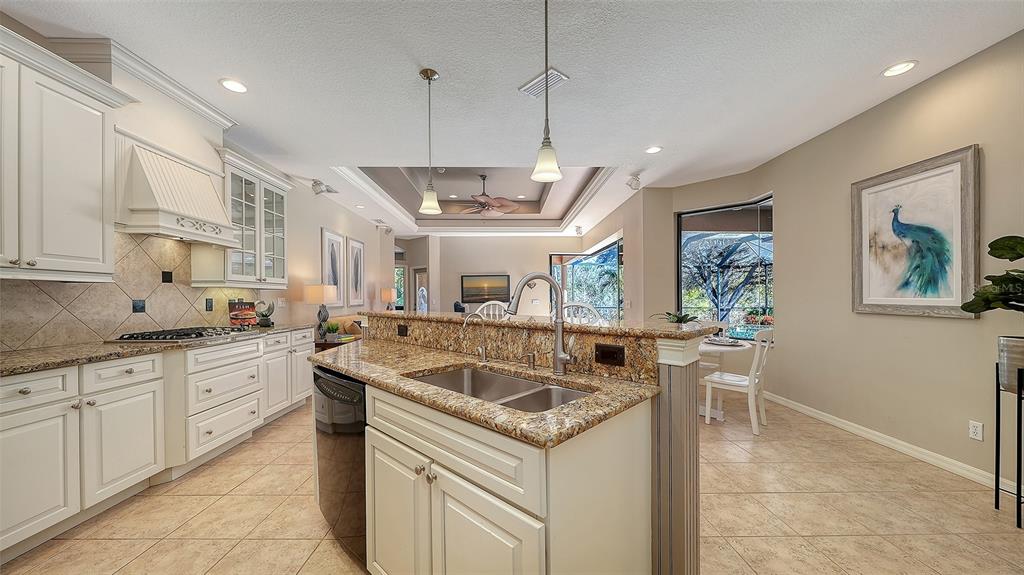 664 Crane Prairie Way Osprey, FL 34229 - Photo 15 of 69 a kitchen with stainless steel appliances granite countertop a sink and a refrigerator
