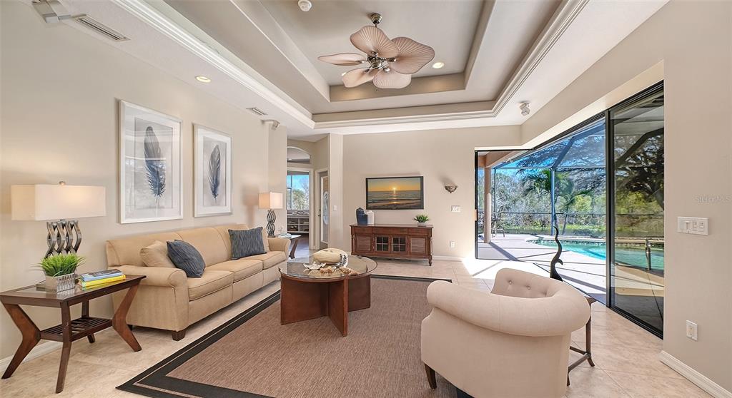 664 Crane Prairie Way Osprey, FL 34229 - Photo 22 of 69 a living room with furniture large window and flat screen tv