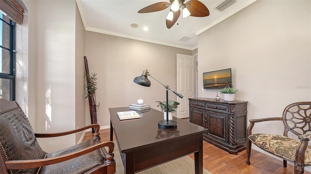 664 Crane Prairie Way Osprey, FL 34229 - Photo 28 of 69 a living room with furniture and a flat screen tv