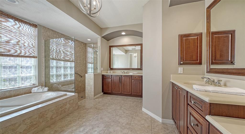 664 Crane Prairie Way Osprey, FL 34229 - Photo 34 of 69 a spacious bathroom with a double vanity sink a mirror and a bathtub