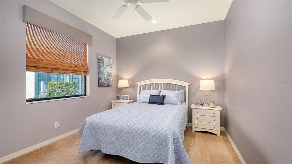 664 Crane Prairie Way Osprey, FL 34229 - Photo 40 of 69 a bedroom with a bed and a large window