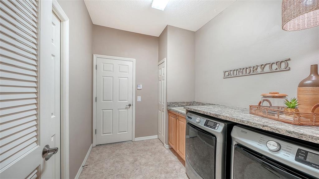 664 Crane Prairie Way Osprey, FL 34229 - Photo 42 of 69 a kitchen with stainless steel appliances granite countertop a sink and a stove