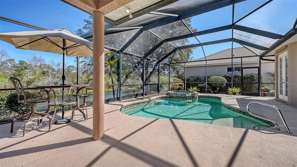 664 Crane Prairie Way Osprey, FL 34229 - Photo 45 of 69 a view of a patio with a table and chairs under an umbrella