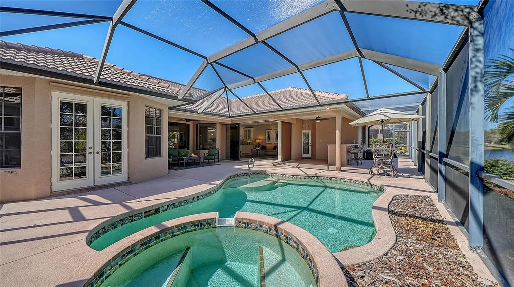 664 Crane Prairie Way Osprey, FL 34229 - Photo 47 of 69 a view of a house with backyard porch and sitting area