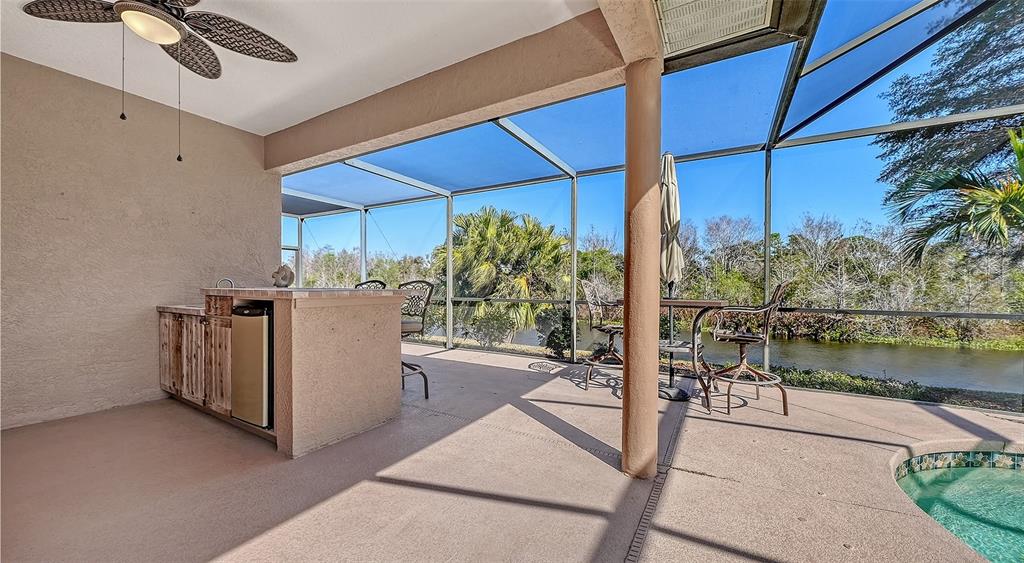 664 Crane Prairie Way Osprey, FL 34229 - Photo 51 of 69 a view of a patio with table and chairs potted plants with wooden floor