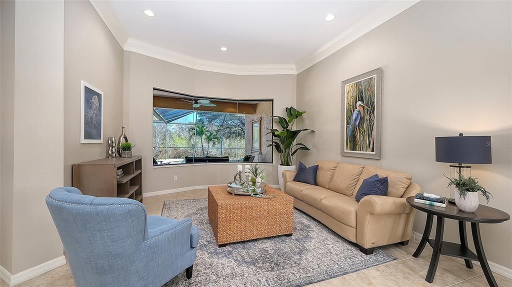 664 Crane Prairie Way Osprey, FL 34229 - Photo 8 of 69 a living room with furniture and a large window