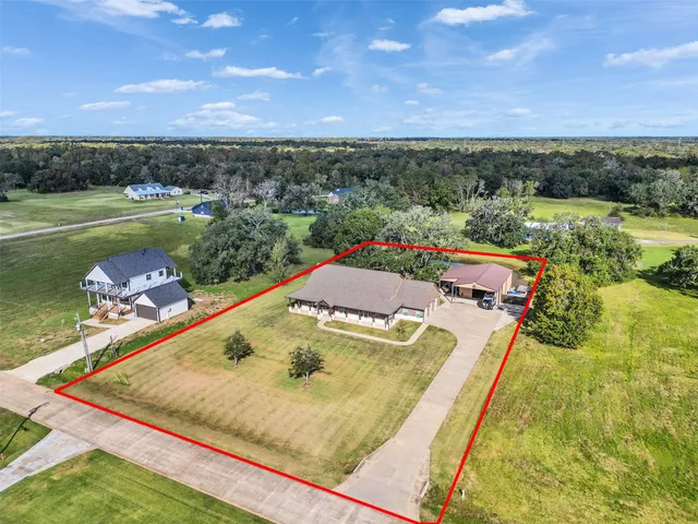 an aerial view of a house with a swimming pool