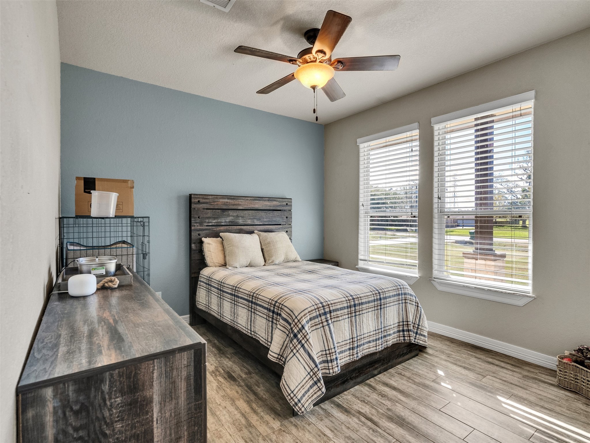 155 Horse Shoe Trail Angleton, TX 77515 - Photo 13 of 29 a bedroom with a bed a dresser and a chandelier