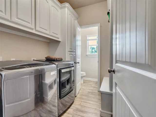 a kitchen with stainless steel appliances granite countertop a stove and a white cabinets