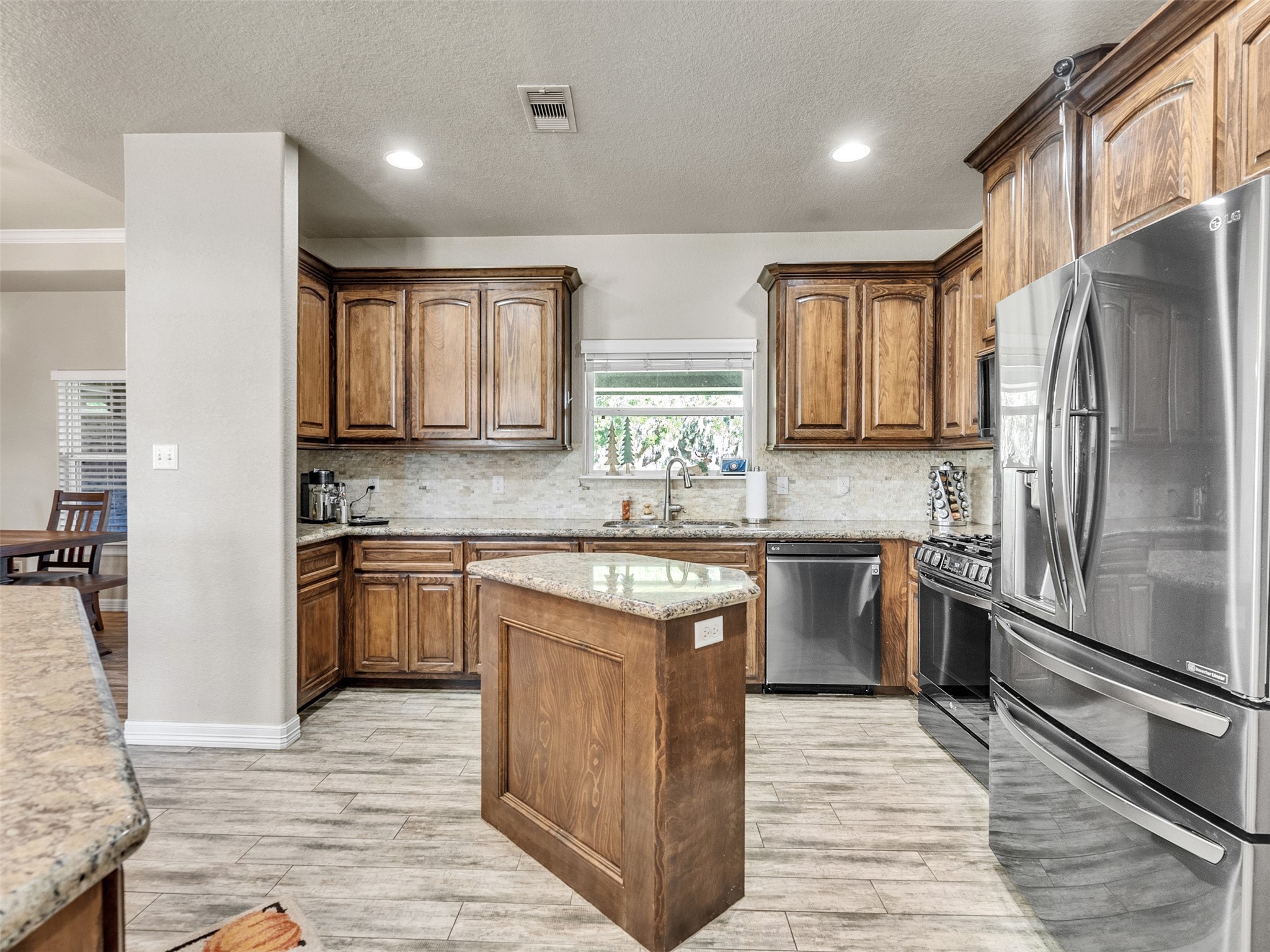 155 Horse Shoe Trail Angleton, TX 77515 - Photo 7 of 29 a kitchen with stainless steel appliances granite countertop a refrigerator sink and stove