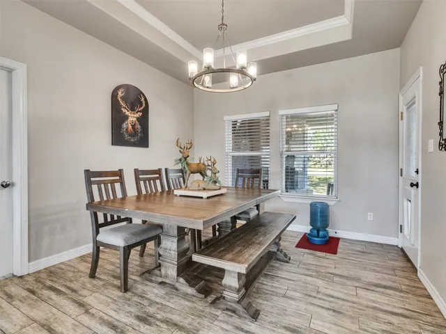 a living room with furniture a window and a chandelier