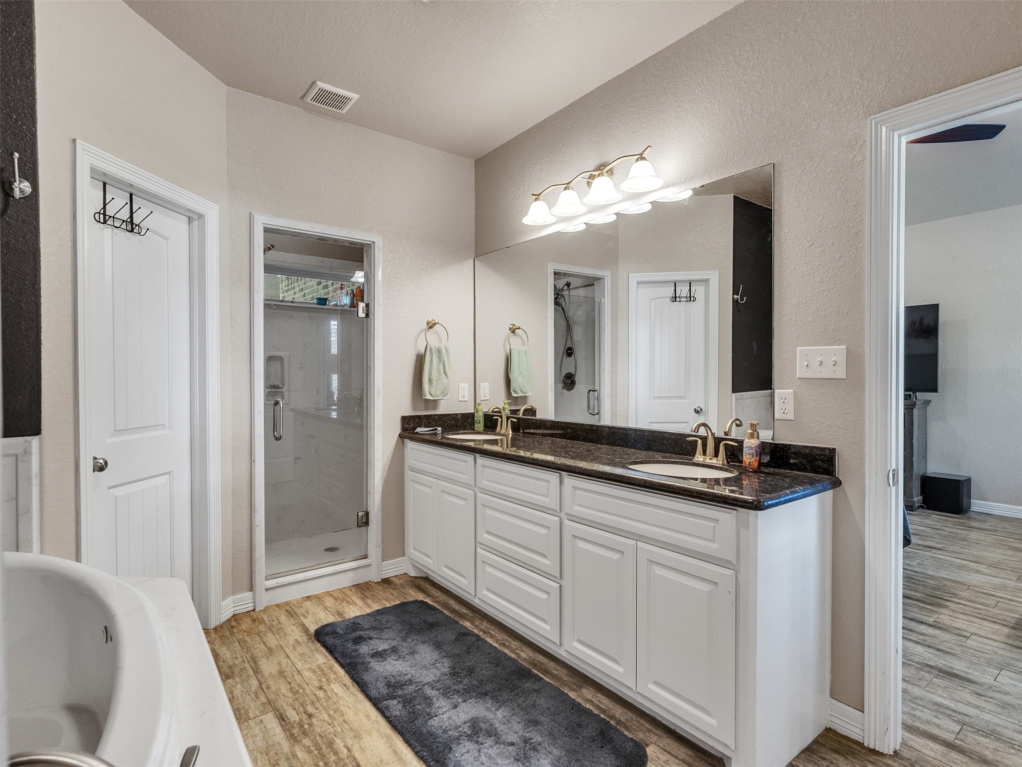 155 Horse Shoe Trail Angleton, TX 77515 - Photo 10 of 29 a spacious bathroom with a double vanity sink a mirror and a shower