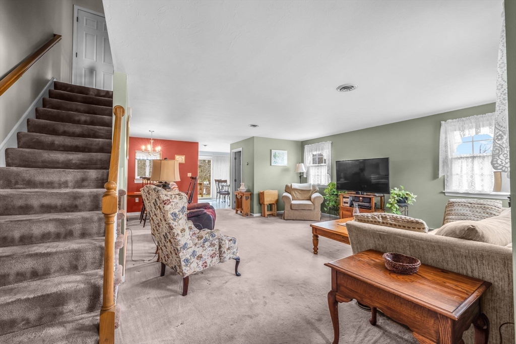 38 High Street, Unit 8 Hanson, MA 02341 - Photo 1 of 37 a living room with furniture and a flat screen tv