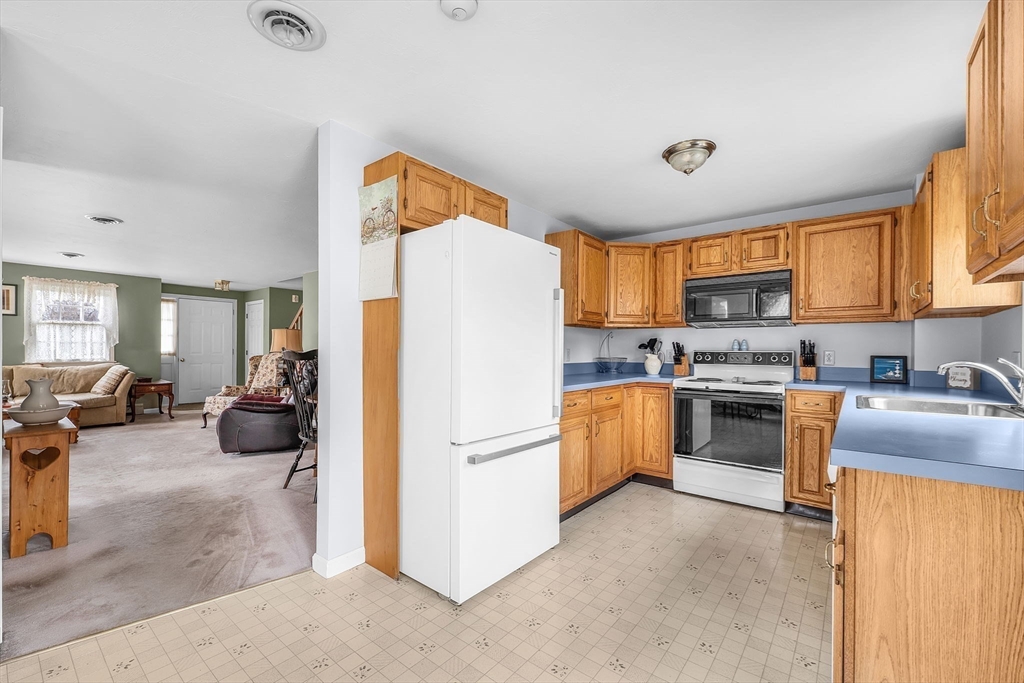 38 High Street, Unit 8 Hanson, MA 02341 - Photo 11 of 37 a kitchen with refrigerator cabinets and a sink