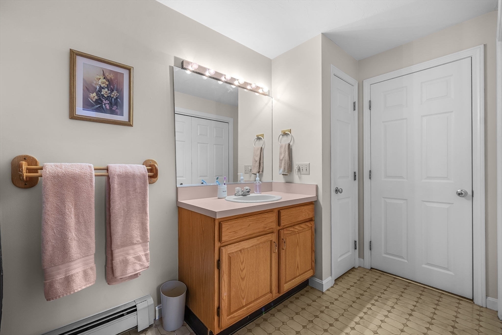 38 High Street, Unit 8 Hanson, MA 02341 - Photo 17 of 37 a bathroom with a sink a mirror and a shower